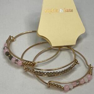 Sophia & Kate gold bangles with pink and gold beads. Set of 3
